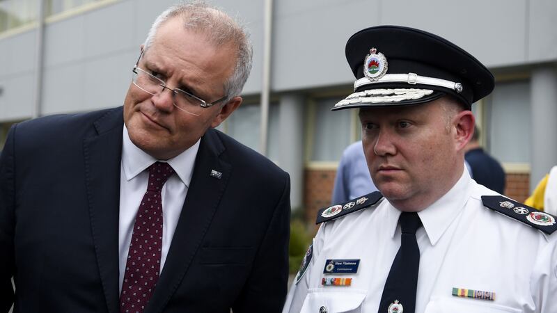 Australian Prime Minister Scott Morrison  and New South Wales  Rural Fire Service  Commissioner Shane Fitzsimmons  visit HMAS Albatross in Nowra, New South Wales, on Sunday. Photograph: Lukas Coch/EPA