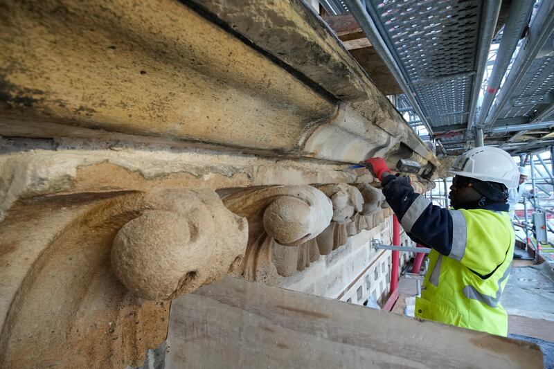 Notre-Dame: a craftsman works on the cathedral's facade. Photograph: Christophe Ena/Pool/AFP via Getty