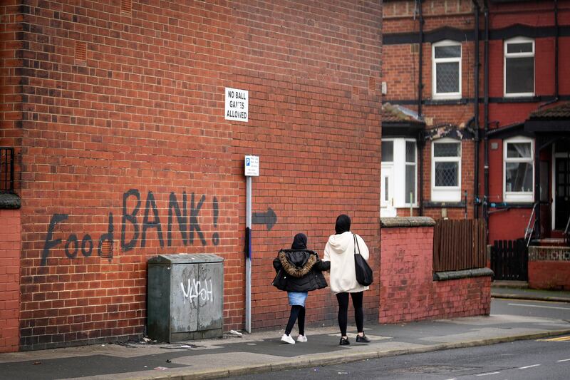 A sign directs people to a local food bank in Leeds: Almost 30 per cent of British children live in relative poverty, rising to 47 per cent for children in black and other ethic minority groups. Photograph: Christopher Furlong/Getty 