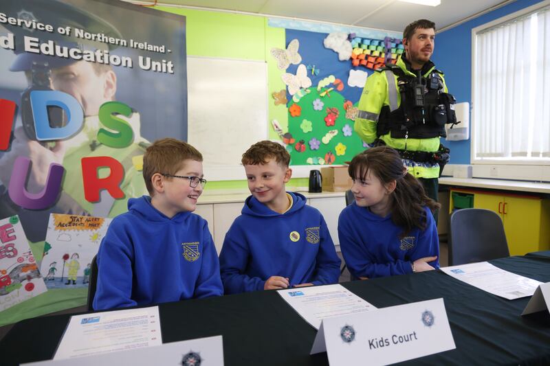 Robert, Mason and Alicia on the ‘bench’ at Artigarvan Primary School, Strabane, where a ‘Kids’ Court’ aims to re-educate drivers about the dangers of speeding. Photograph: Bryan O’Brien
