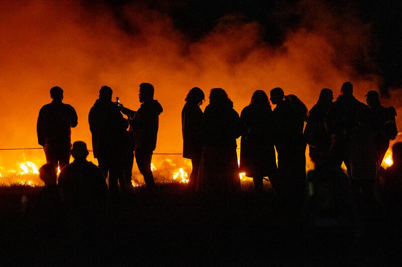 People stand by the fire at the Bealtaine festival. Photograph: Tom Honan/The Irish Times