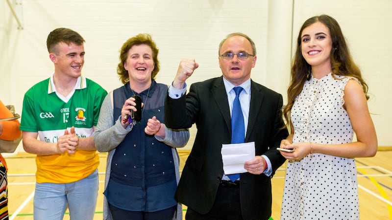 Newly elected Sinn Féin MP for West Tyrone Barry McElduff MP rises his fist in celebration with his family. Photograph: Liam McBurney/PA Wire