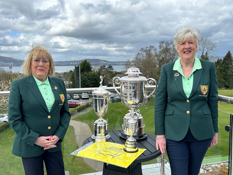 Audrey Gibson (left) and Kathy Mackey with replicas of three of Rory McIlroy’s Major trophies at Holywood Golf Club. Photograph: Freya McClements