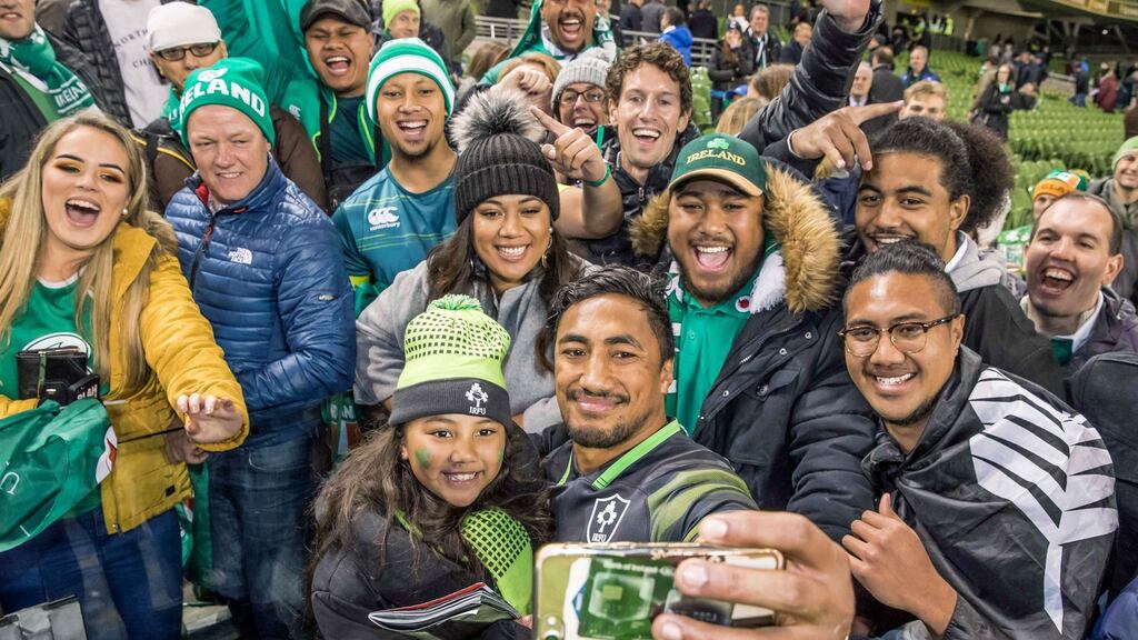 Bundee Aki takes a picture with his daughter Adrianna Aki and family members after the match. Photograph: Morgan Treacy/Inpho