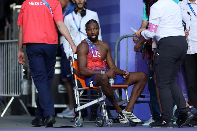 Bronze medalist Noah Lyles of Team United States is taken off from the track with a wheelchair. Photograph: Christian Petersen/Getty
