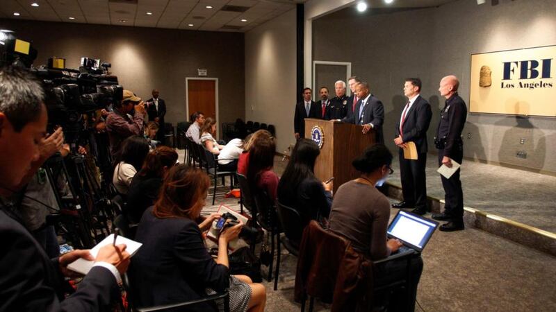 Law enforcement officials talk to reporters at a news conference yesterday regarding a shooting incident that occurred the previous day at Los Angeles airport. Photograph: Reuters