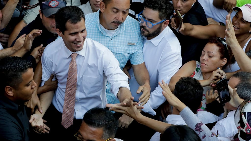Venezuela’s opposition leader and self-proclaimed interim president Juan Guaidó greets supporters during a rally in Caracas, Venezuela on Monday. Photograph: Natacha Pisarenko/AP