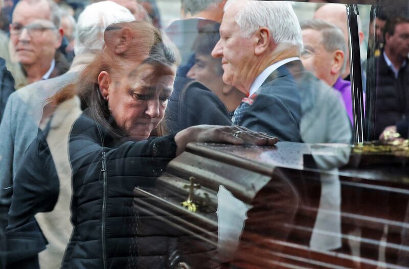 Dickie Rock daughter, Sarah-Jane places a hand on his coffin after the funeral Mass at the Church of the Most Precious Blood in Cabra. Photograph: Colin Keegan/Collins Dublin