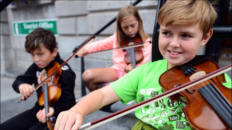 Patrick Connolly (10), Yvie Sharkey (9) and Tommy Sweeney (10) all from Clogherhead, Co Louth,  during Fleadh Cheoil Na hEireann in Drogheda last August. Photograph: Bryan O’Brien