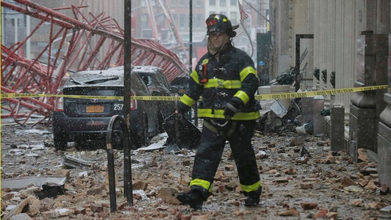 A New York City fireman walks in the rubble of a massive construction crane collapse on a street in downtown Manhattan in New York, February 5th, 2016. Photograph: Brendan McDermid/Reuters