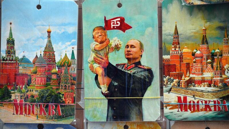 A  drawing depicting Russian President Vladimir Putin holding a baby with the face of US President Donald Trump. Photograph: Mladen Antonov/AFP/Getty Images
