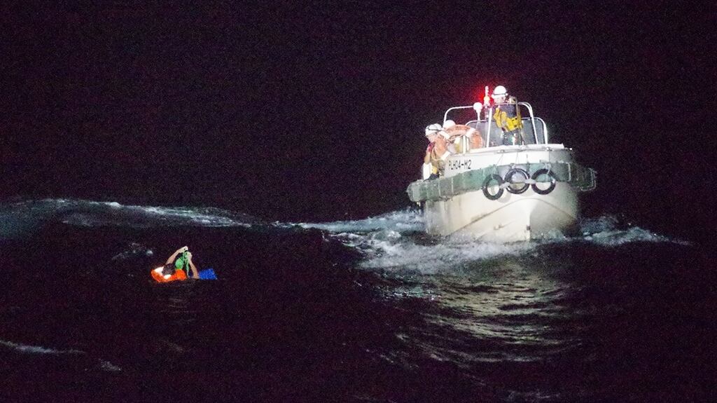 Coast guards rescuing a Filipino man off Amami Oshima island during a search for a cargo ship with 43 people on board. Photograph: 10th Regional Coast Guard/AFP/Getty Images.