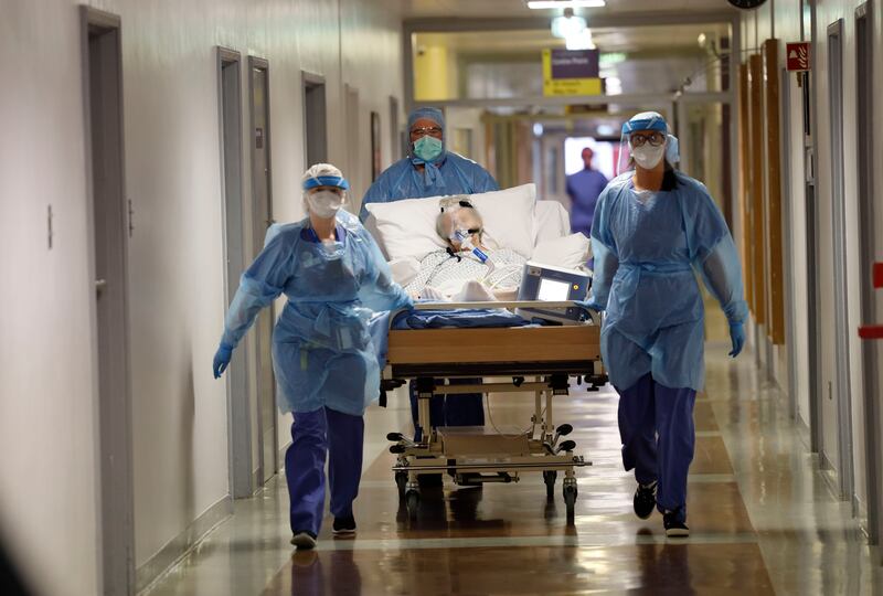 A Covid patient is transferred with medical staff in full PPE at St Vincent's University Hospital. Photograph: Alan Betson