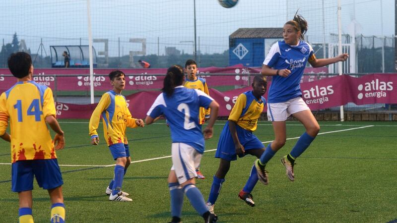 Andrea Gómez, the striker for AEM Lleida,  heads a ball against a boys team in Lleida, Spain, April 25, 2017. Photograph: Samuel Aranda/The New York Times