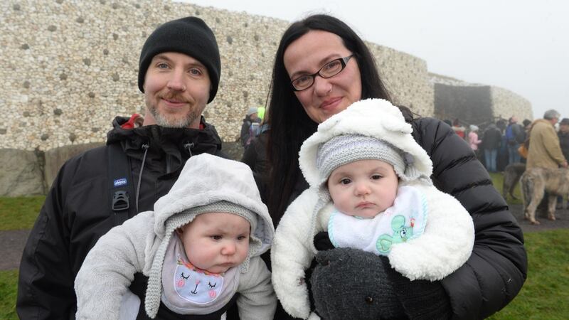 David Pepper and Virginia Apicella, from Lurgan with twins Elsa and Lavinia, outside the burial chamber at Newgrange in Co, Meath for the winter solstice. Photograph: Dara Mac Dónaill / The Irish Times