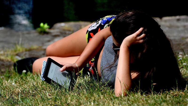 Lunchtime read on the banks of the Canal during the June heatwave.Photograph: Cyril Byrne