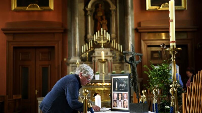 Members of the public sign a book of condolence at the Pro-Cathedral in Dublin’s city centre for those killed in the Berkeley balcony collapse. Photograph: Brian Lawless/PA Wire
