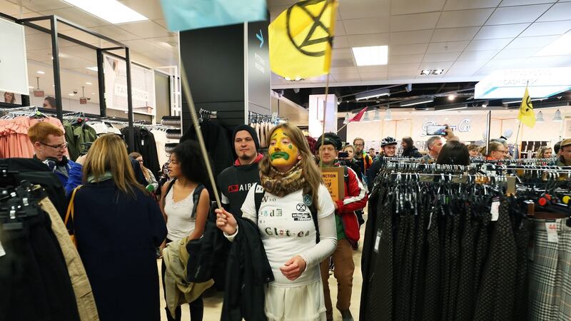 Extinction Rebellion protestors demonstrate in Penneys. Photograph:   Brian Lawless/PA Wire