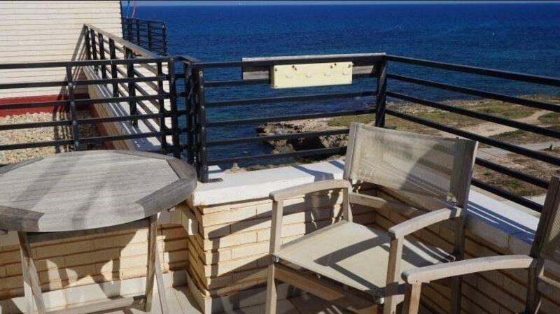 The sea is strikingly close to this three-bedroom penthouse duplex in Torrevieja