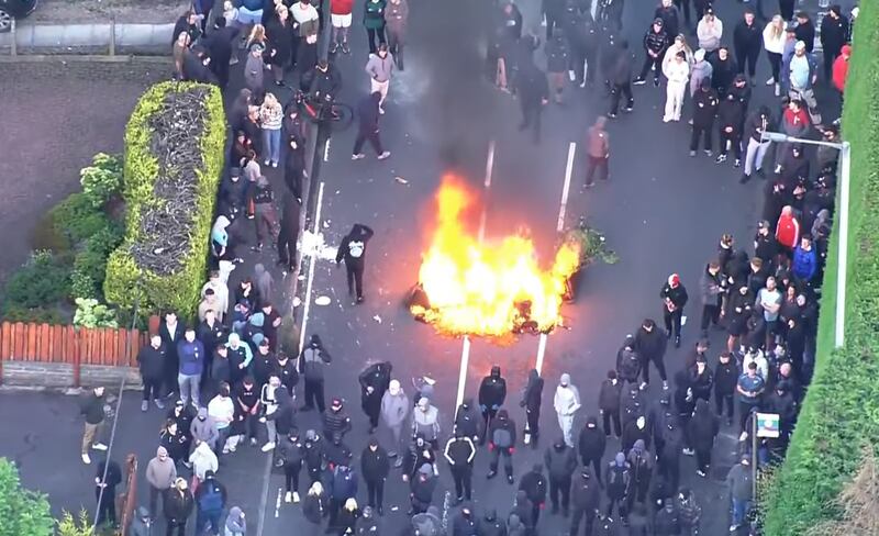 A large fire set by the crowd on the Antrim Road. Photograph: Sky News helicopter footage