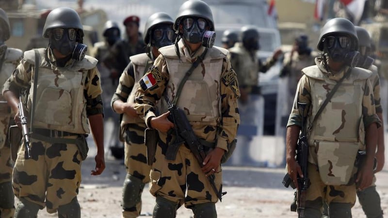 Army soldiers wear gas masks before clashes with members of the Muslim Brotherhood and supporters of deposed Egyptian president Mohamed Morsi at Republican Guard headquarters in Nasr City, a suburb of Cairo, on  July 8th. Photograph: Reuters