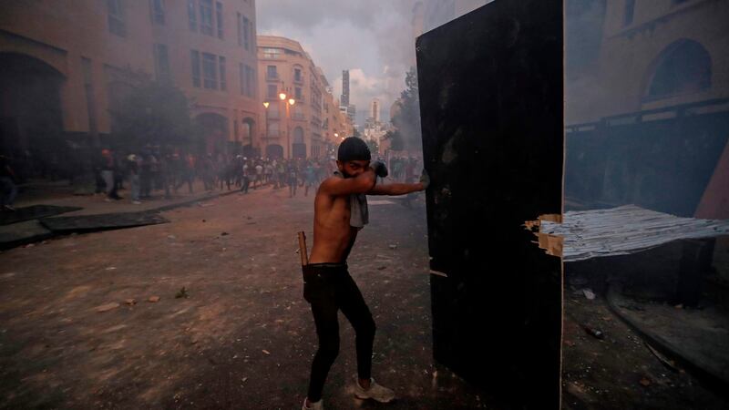 A protester covers his face from tear gas fired by security forces amid clashes in Beirut after a deadly explosion destroyed large parts of the city, on August 9th. Photograph:  Joseph Eid/AFP via Getty Images