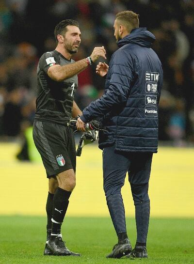 A dejected Buffon embraces and Gianluigi Donnarumma after the play-off with Sweden.  Photograph: Getty Images