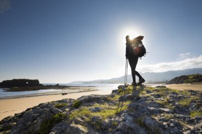 A lone pilgrim on La Isla Beach on Camino del Norte.