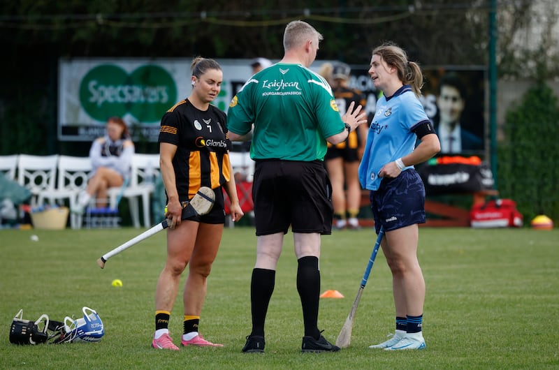 Kilkenny captain Katie Power and Dublin captain Aisling Maher, both in shorts, talk with referee Ray Kelly before Saturday's Leinster senior camogie semi-final. All the players had to change into skorts before the game could start. Photograph: Nick Bradshaw