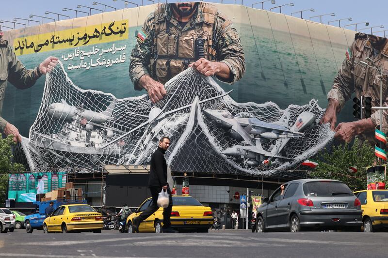 Vehicles drive past a giant billboard reading 'The Strait of Hormuz remains closed' at Revolution Square in Tehran on Tuesday. Photograph: Atta Kenare/AFP via Getty