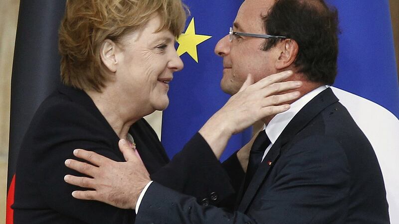 Angela Merkel and Francois Hollande embrace in 2012. Photograph:  Jacky Naegelen/Reuters