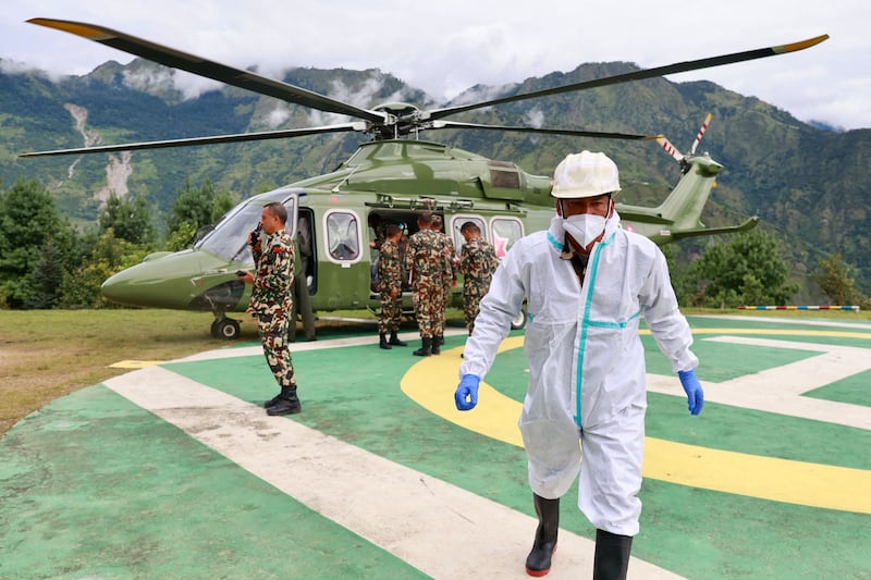A Nepal army helicopter carries bodies from the flood-affected area in Nepal's Rasuwa district. Photograph: Prabin RANABHAT/AFP via Getty Images