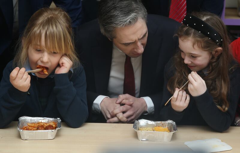 Then-taoiseach Simon Harris pictured with students at the announcement on the roll-out of the Hot School Meals Programme. Photograph: Stephen Collins/Collins Photos