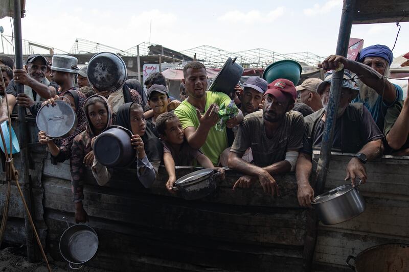 Internally displaced Palestinians gather to collect food donated by a charity in Khan Yunis camp in southern Gaza Strip on Friday. Photograph: Haitham Imad/EPA