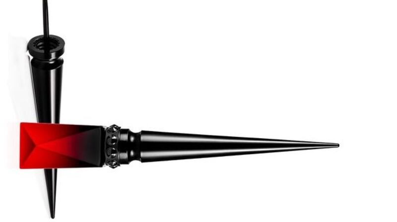 For a subtle doff of the cap to red, apply a black cat-eye flick, and trace a thin line of a red liquid liner like Christian Louboutin Oeil Vinyle Luminous Ink Liner in Red (€75) along the top.