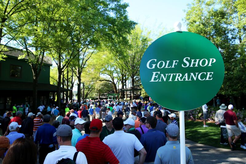  Patrons line up at the entrance to the golf shop at Augusta National Golf Club.  Photo:  Andrew Redington/Getty Images