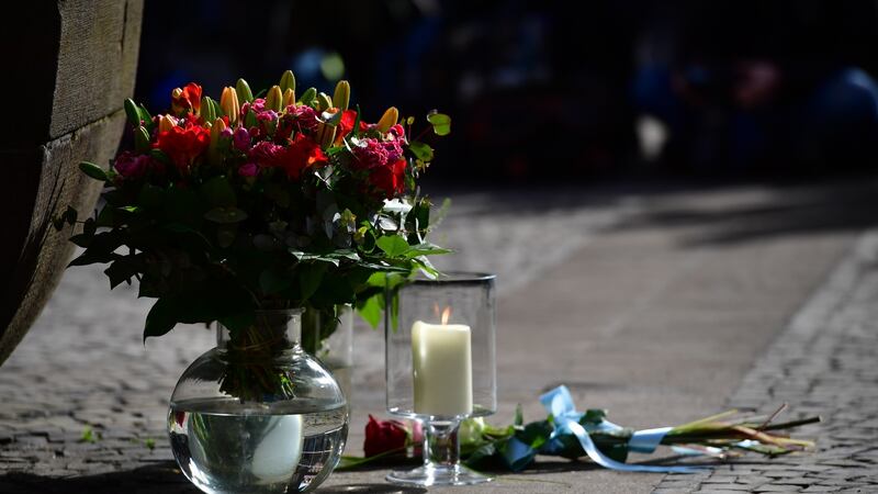 Flowers lay in front of the statue at the Kiepenkerl pub by the site of a deadly  attack with a van in  Münster, western Germany. Photograph: Alexander Koerner/Getty Images.