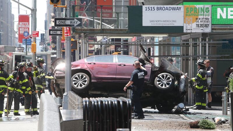 A red car positioned on its side after it reportedly struck pedestrians  in Times Square in New York City, New York.  Photograph: Gary He/EPA