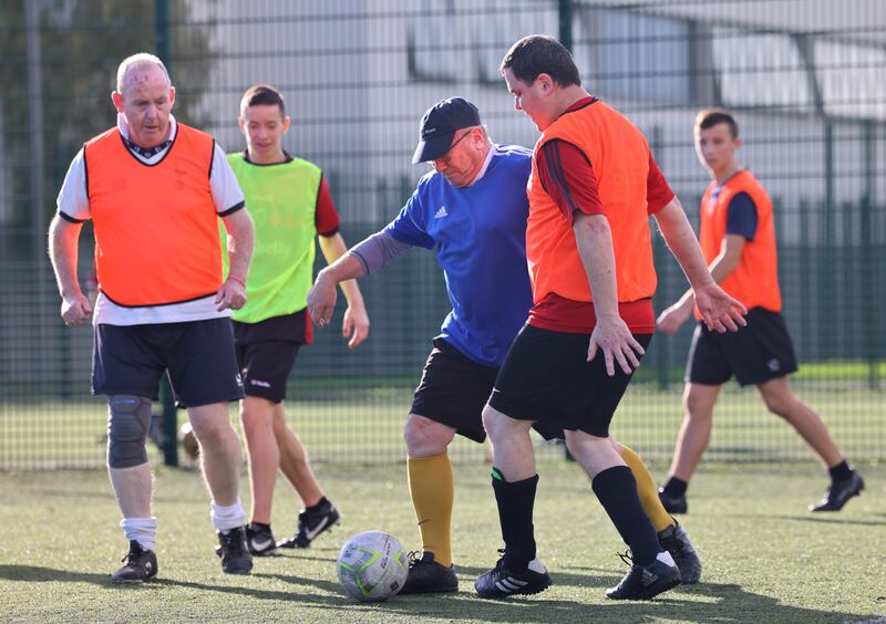 
Derek Reid (left) Declan Webb (blue) and Brian Murphy during the walking football for members of the Men’s Shed at Deaf Village Ireland, Cabra, Dublin. Photograph: Dara Mac Dónaill