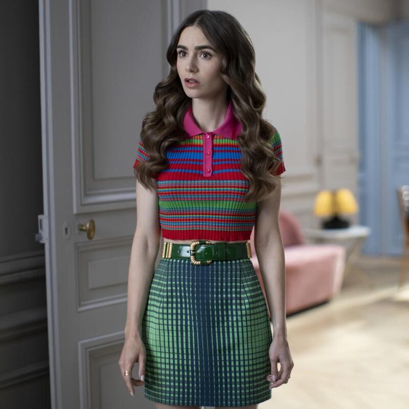 Lily Collins is required to wear colour-clashing pastels that threaten to rip a hole in the space-time continuum. Photograph: Carole Bethuel/Netflix