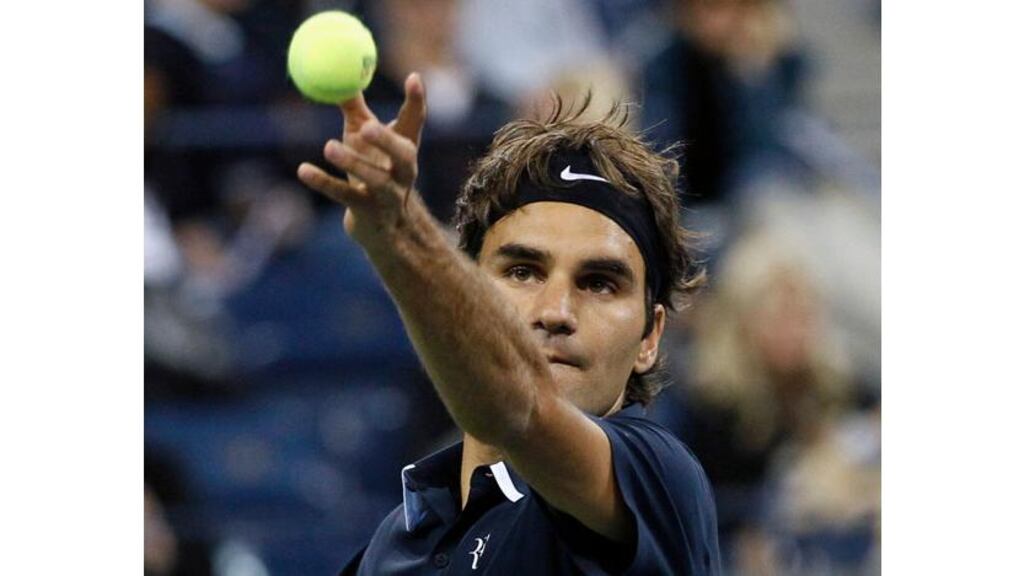 Roger Federer keeps his eye on the ball as he prepares to serve to Robin Soderling. Strong winds at Flushing Meadows made life difficult for all the players last night. Photograph: Mike Segar/Reuters