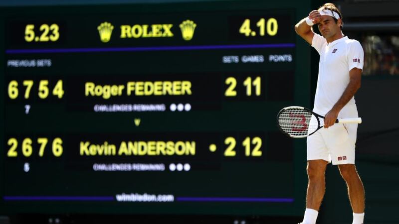 Roger Federer  wipes his forehead during his quarter-final match against Kevin Anderson at Wimbledon. Photograph:    Michael Steele/Getty Images