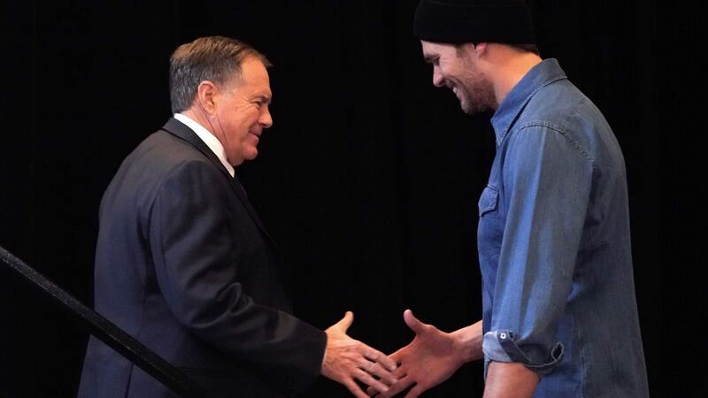 New England Patriots quarterback Tom Brady  greets head coach Bill Belichick at a media event in Atlanta. Photograph:  Timothy A Clary/AFP/Getty Images
