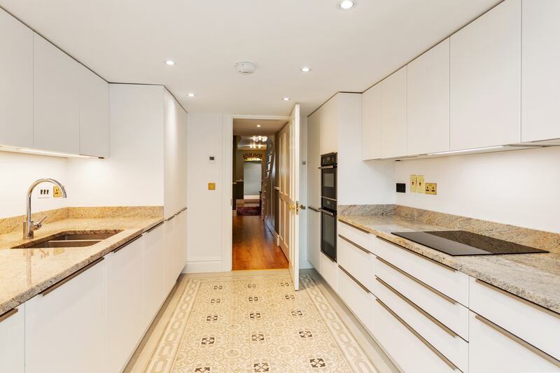 A galley-style kitchen is accessed off the end of the hall