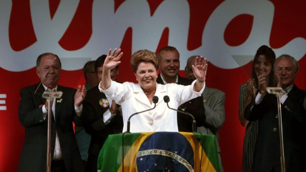 Re-elected Brazilian president Dilma Rousseff (C) addresses a press conference in Brasilia last night after winning a narrow re-election victory. Photograph: Epa/Fernando Bizerra