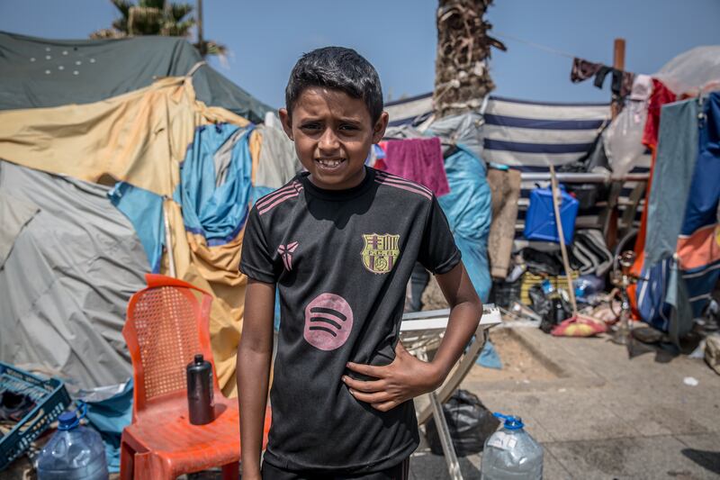 Ali (10) stands in front of his family's shelter in Ramlet al Baida in Beirut. Photograph: Sally Hayden