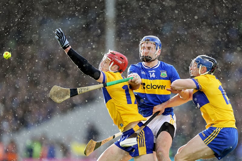 Clare's John Conlon and David McInerney battle for possession with Tipperary's John McGrath. Photograph: Laszlo Geczo/Inpho