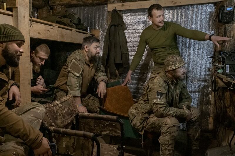 Ukrainian soldiers watch a monitor as they track movements of a group of Russian soldiers  moments after giving the co-ordinates to a mortar team to strike that position on the outskirts of Bakhmut. Photograph: Mauricio Lima/New York Times
                      
