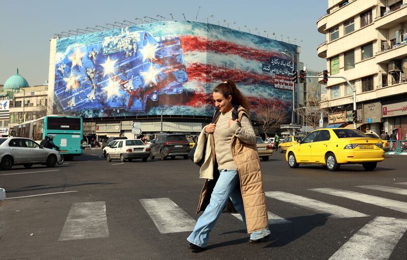 Iranians walk near a huge anti-US billboard hanging at the Enqelab square in Tehran, Iran, January 27th 2026. Photograph: EPA