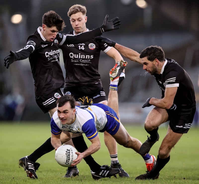 Darragh Canavan is tackled by Kilcoo's Eugene Branagan, Jerome Johnston and Niall Branagan in the Ulster senior club championship final in Armagh in December. Photograph: Ben Brady/Inpho